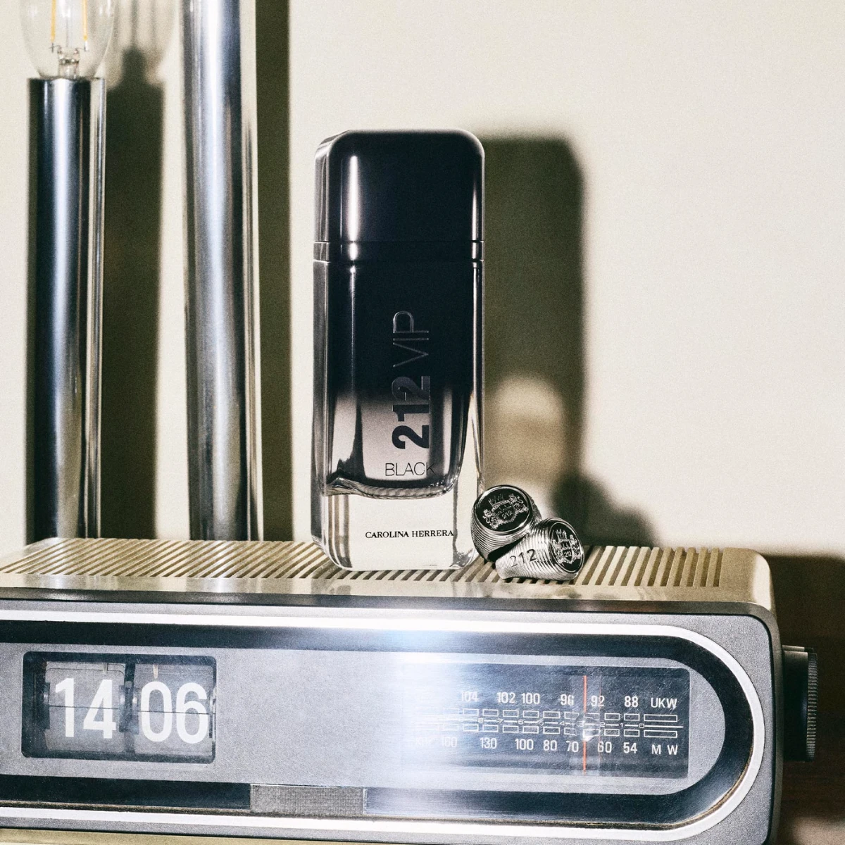 212 VIP Black beside a vintage radio