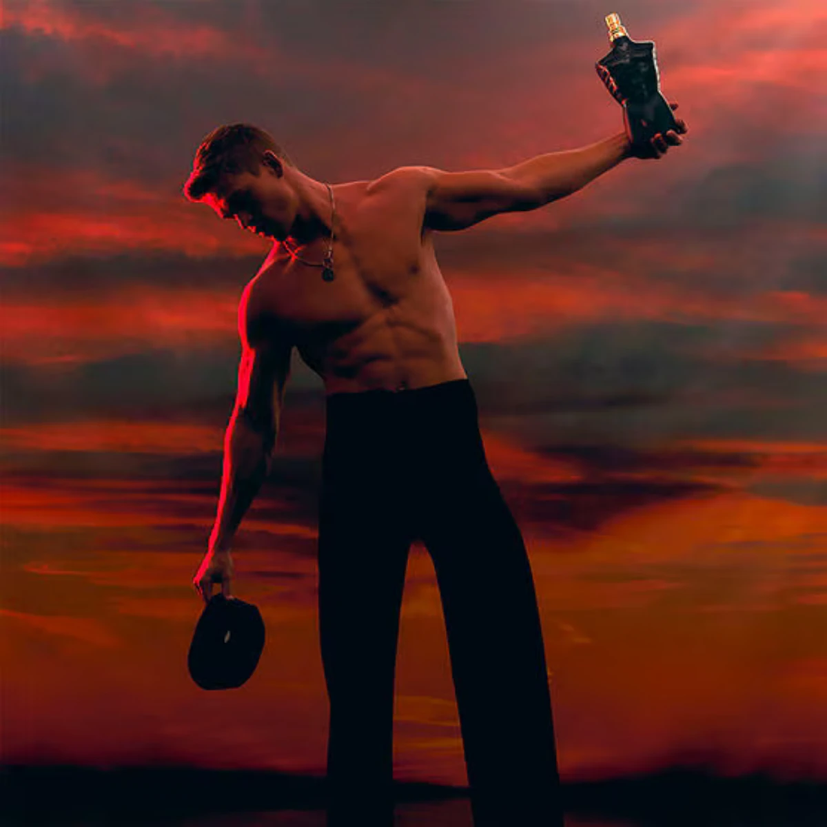 A man holding Le Male Le Parfum